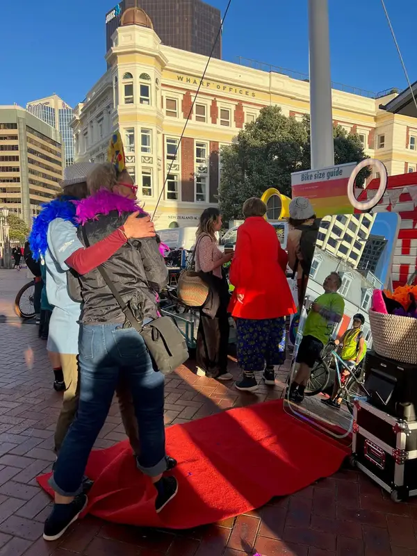 Guests using the Large Mirror booth on a red carpet at an outdoor event