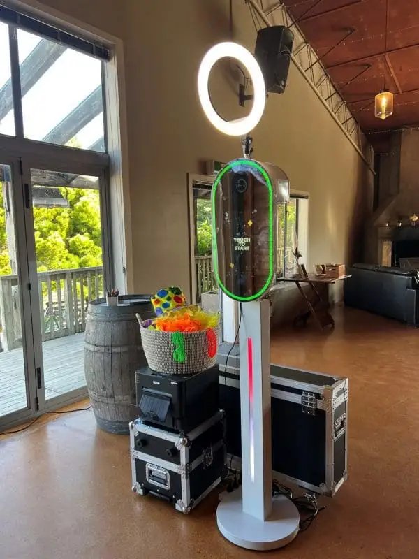 Selfie Mirror with a ring light and slim white pedestal beside a printer and props